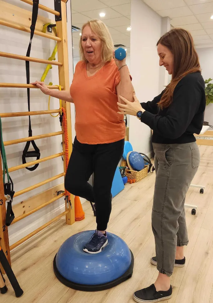 A Universus therapist guiding a patient through balance training